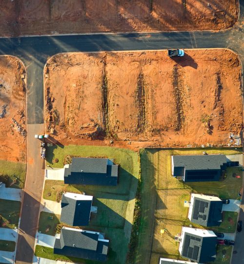 Aerial view of construction site with new tightly packed homes in South Carolina. Family houses as example of real estate development in american suburbs.